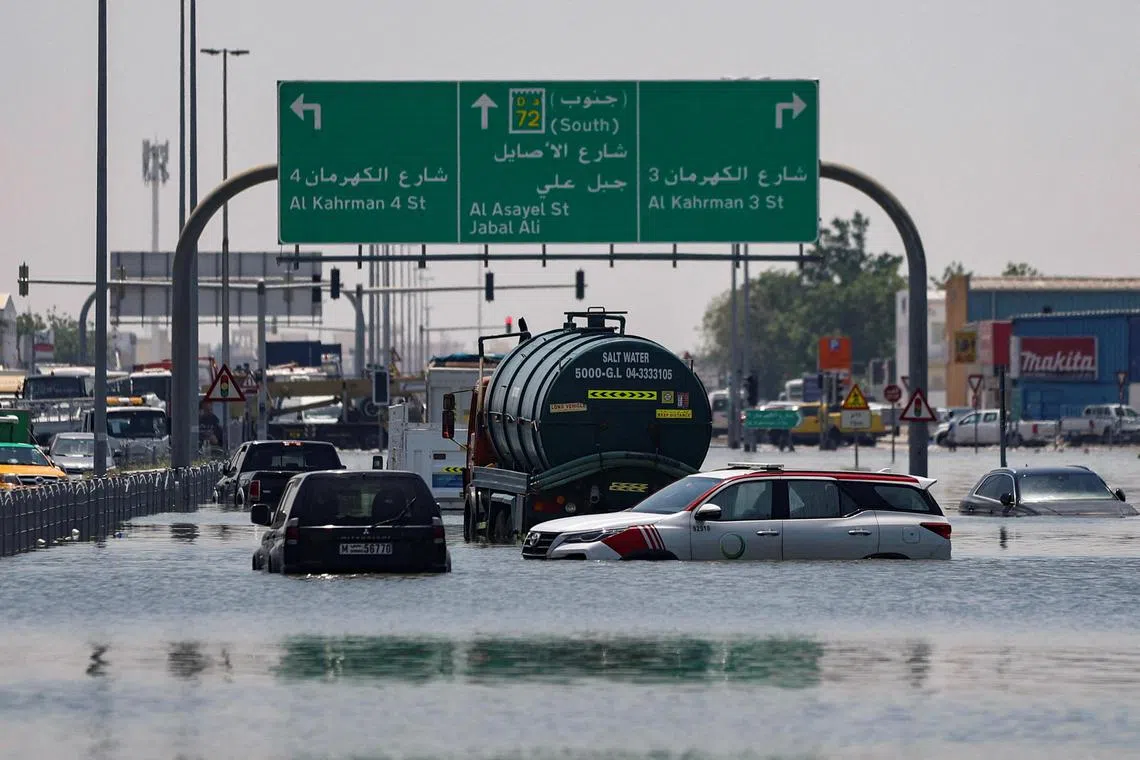 FILE PHOTO: Cars are stranded in flood water on a blocked highway following heavy rainfall, in Dubai, United Arab Emirates, April 19, 2024. REUTERS/Amr Alfiky/File Photo