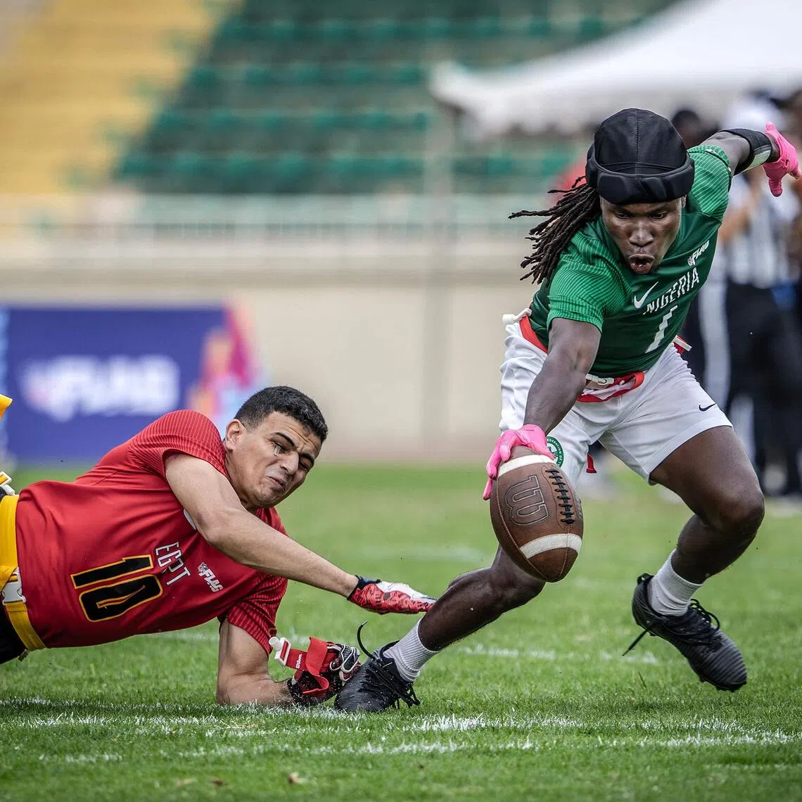A Nigeria national senior flag footballer going for a touchdown as an Egypt player pulls his flag during their game at the NFL Flag Africa Continental Championships at Nyayo Stadium in Nairobi on July 10, 2026.