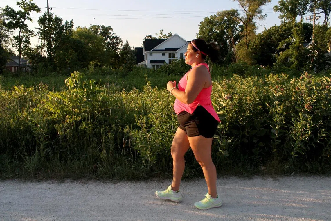 Francisca Pike, who started speed-walking after being diagnosed with epilepsy, walks along the Illinois Prairie Path in Elmhurst, Ill., June 28, 2022. 