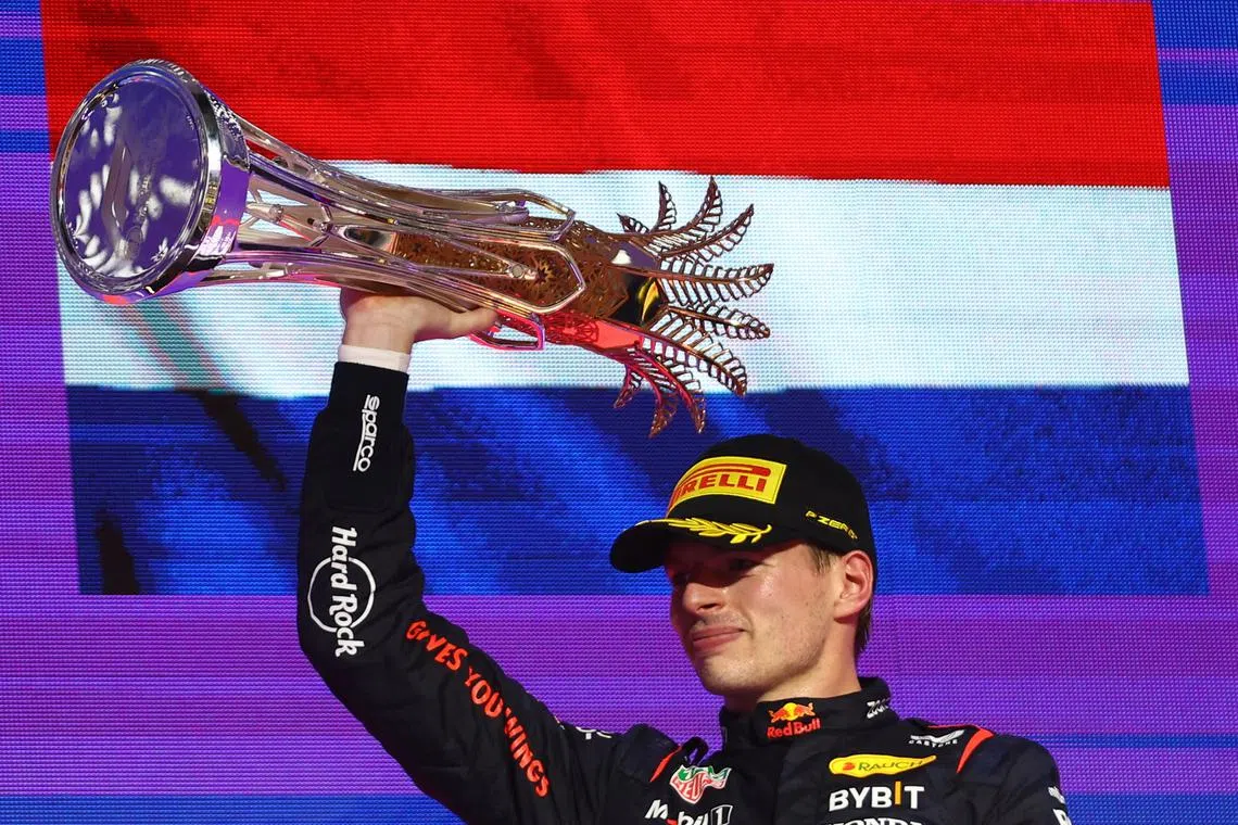 Formula One F1 - Saudi Arabian Grand Prix - Jeddah Corniche Circuit, Jeddah, Saudi Arabia - March 9, 2024 Red Bull's Max Verstappen celebrates with a trophy on the podium after winning the Saudi Arabian Grand Prix REUTERS/Rula Rouhana