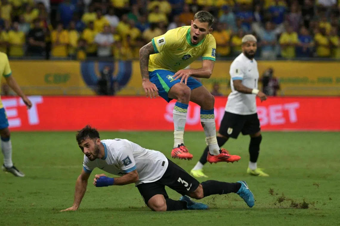 Uruguay's defender #03 Marcelo Saracchi and Brazil's midfielder #05 Bruno Guimaraes fight for the ball during the 2026 FIFA World Cup South American qualifiers football match between Brazil and Uruguay at the Arena Fonte Nova stadium in Salvador, Brazil, on November 19, 2024. (Photo by NELSON ALMEIDA / AFP)