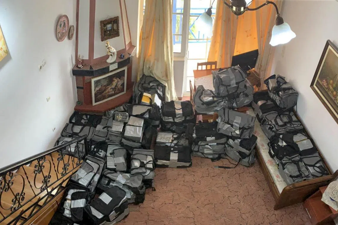 Travel bags filled with cocaine packages are seen inside an apartment after a police raid in Astakos, Greece, January 25, 2020 in this handout image. Greek Police/Handout via REUTERS/File Photo