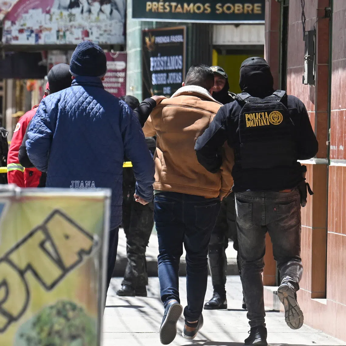 Senior prosecutor and former lawyer for Evo Morales, Martin Irusta, is escorted by members of the Patrol, Action and Reaction Unit (DELTA) to the facilities of the Special Force to Fight Drug Trafficking (FELCN), where Bolivia's Attorney General Roger Mariaca is being held, days after the United States revoked his visa over alleged links to drug trafficking, in El Alto, Bolivia, October 1, 2026. REUTERS/Claudia Morales