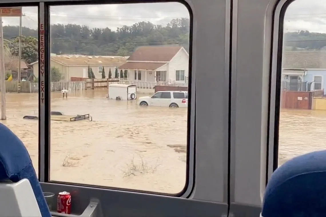 A general view of a flooded street in Pajaro, California, U.S., March 11, 2023, this screen grab obtained from a social media video.
