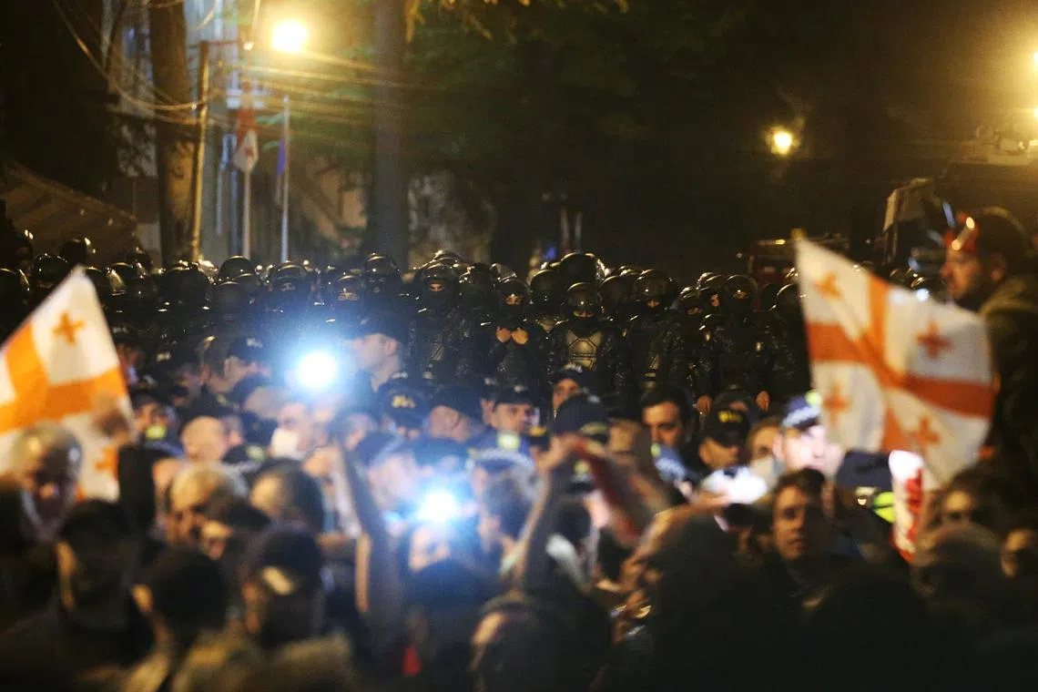 Georgian law enforcement officers stand guard during a protest against a draft bill on \"foreign agents\" in Tbilisi, Georgia April 16, 2024. REUTERS/Irakli Gedenidze
