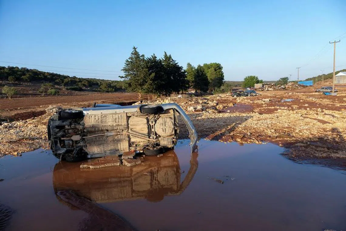 FILE PHOTO: A view shows a damaged car, after a powerful storm and heavy rainfall hit Libya, in Derna, Libya September 12, 2023. REUTERS/Esam Omran Al-Fetori