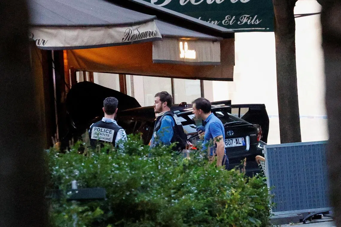 Police officers working at the scene, after a car hit people sitting on the terrace of a Paris cafe, on July 17. 