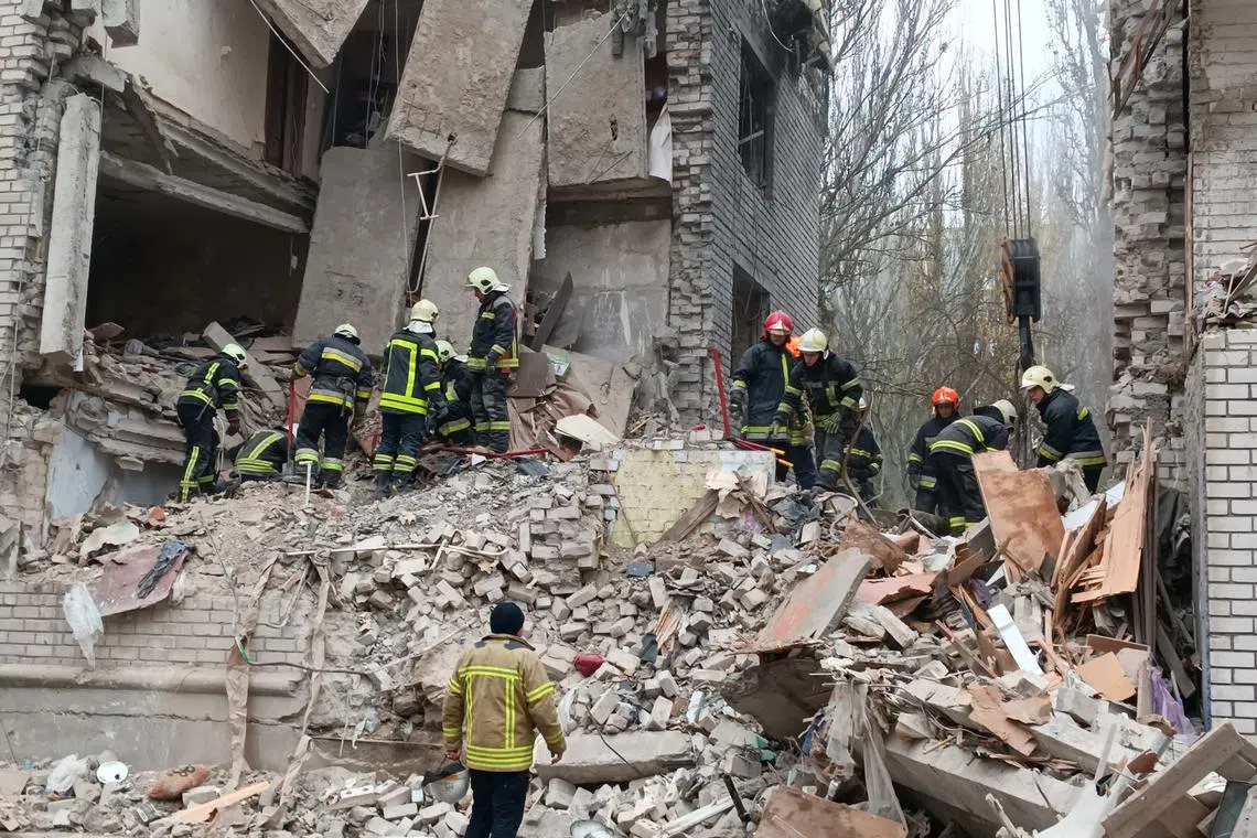 Rescuers work at a site of a residential building heavily damaged by a Russian missile attackin Mykolaiv on Nov 11, 2022.