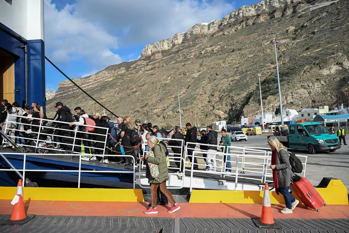 Passengers board a ferry as they leave following high seismic activity, on the island of Santorini, Greece, February 3, 2025. REUTERS/Nikos Christofakis