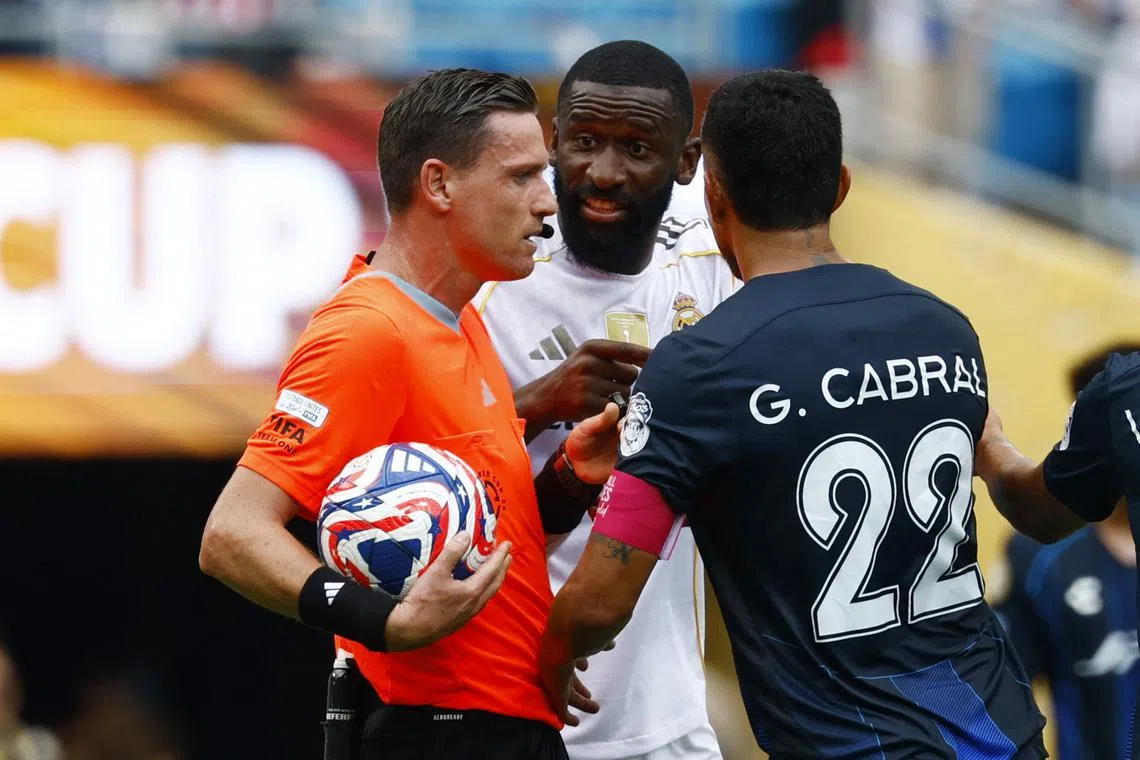 FILE PHOTO: Soccer Football - FIFA Club World Cup - Group H - Real Madrid v Pachuca - Bank of America Stadium, Charlotte, North Carolina, U.S. - June 22, 2025, Real Madrid's Antonio Rudiger and Pachuca's Gustavo Cabral remonstrate with referee Ramon Abatti REUTERS/Susana Vera/File Photo