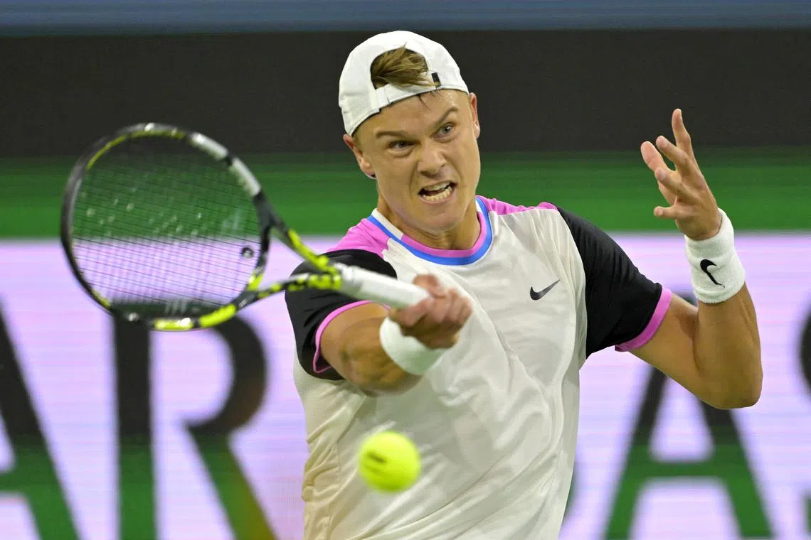 Mar 13, 2024; Indian Wells, CA, USA; Holger Rune (DEN) hits a shot as he defeated Taylor Fritz (USA) in the fourth round of the BNP Paribas Open at the Indian Wells Tennis Garden. Mandatory Credit: Jayne Kamin-Oncea-USA TODAY Sports