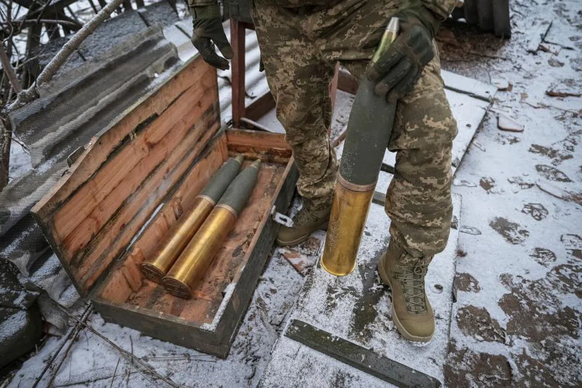 A Ukrainian serviceman of 80th Separate Galician Air Assault Brigade prepares shells to fire a L119 howitzer towards Russian troops, amid Russia's attack on Ukraine, at a position near Bakhmut in Donetsk region, Ukraine January 25, 2024. REUTERS/Inna Varenytsia/File Photo
