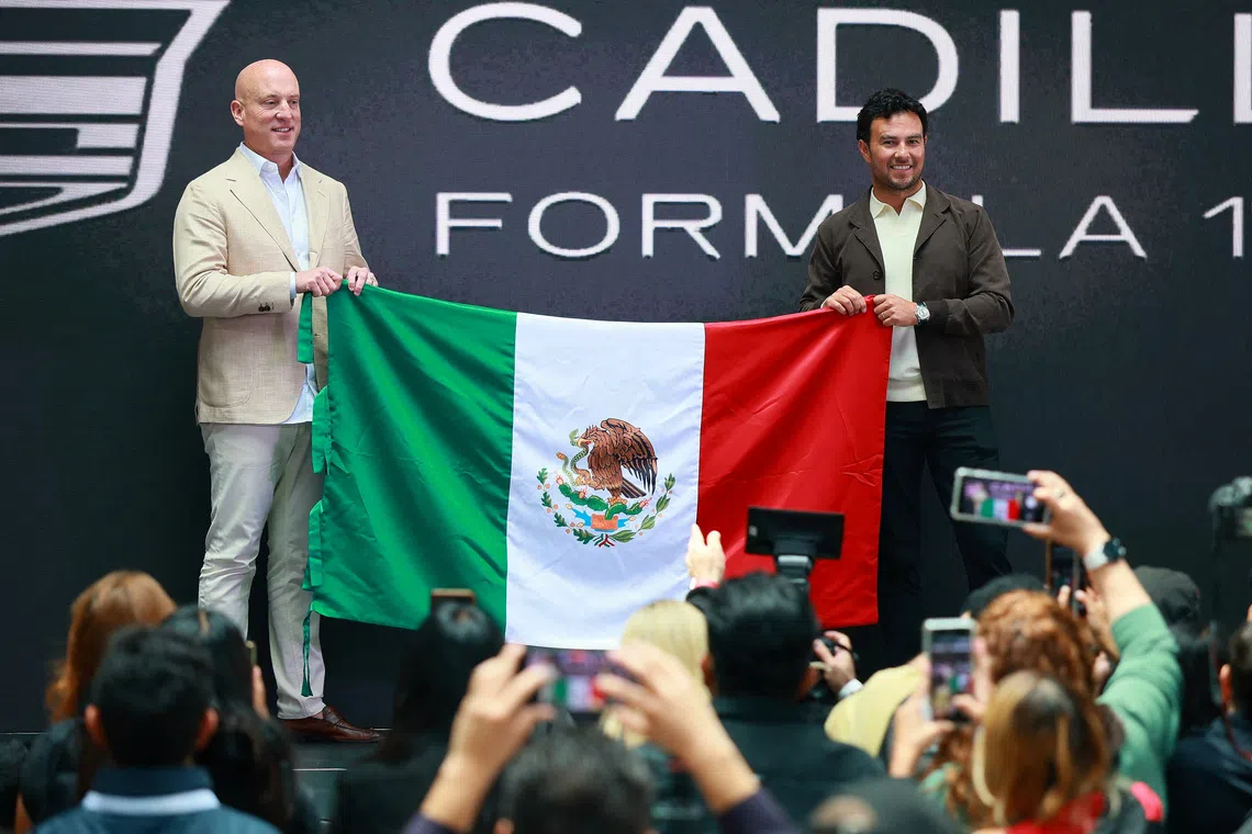 FILE PHOTO: Formula One F1 - Mexican F1 driver Sergio Perez to speak to media after announcing his Cadillac team signing - Plaza Carso, Mexico City - August 27, 2025 Formula One driver Sergio Perez poses with Cadillac F1 team CEO, Dan Towriss and the flag of Mexico during his announcement of signing with the new Cadillac Formula One team for the 2026 season REUTERS/Eloisa Sanchez/File Photo