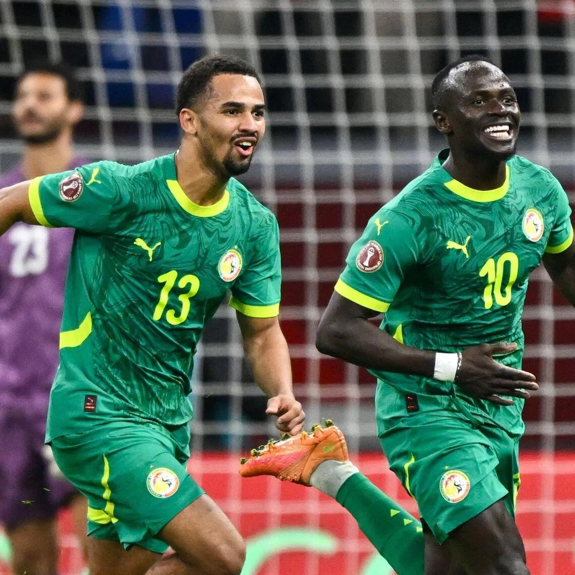 Senegal forward Sadio Mane celebrates his goal with teammate Iliman Ndiaye.