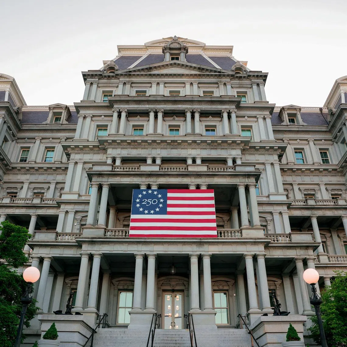 FILE PHOTO: An America250 flag decorates the Eisenhower Executive Office Building, which U.S. President Donald Trump's administration has proposed to paint white, in Washington, D.C., U.S., May 7, 2026. REUTERS/Kylie Cooper/File Photo