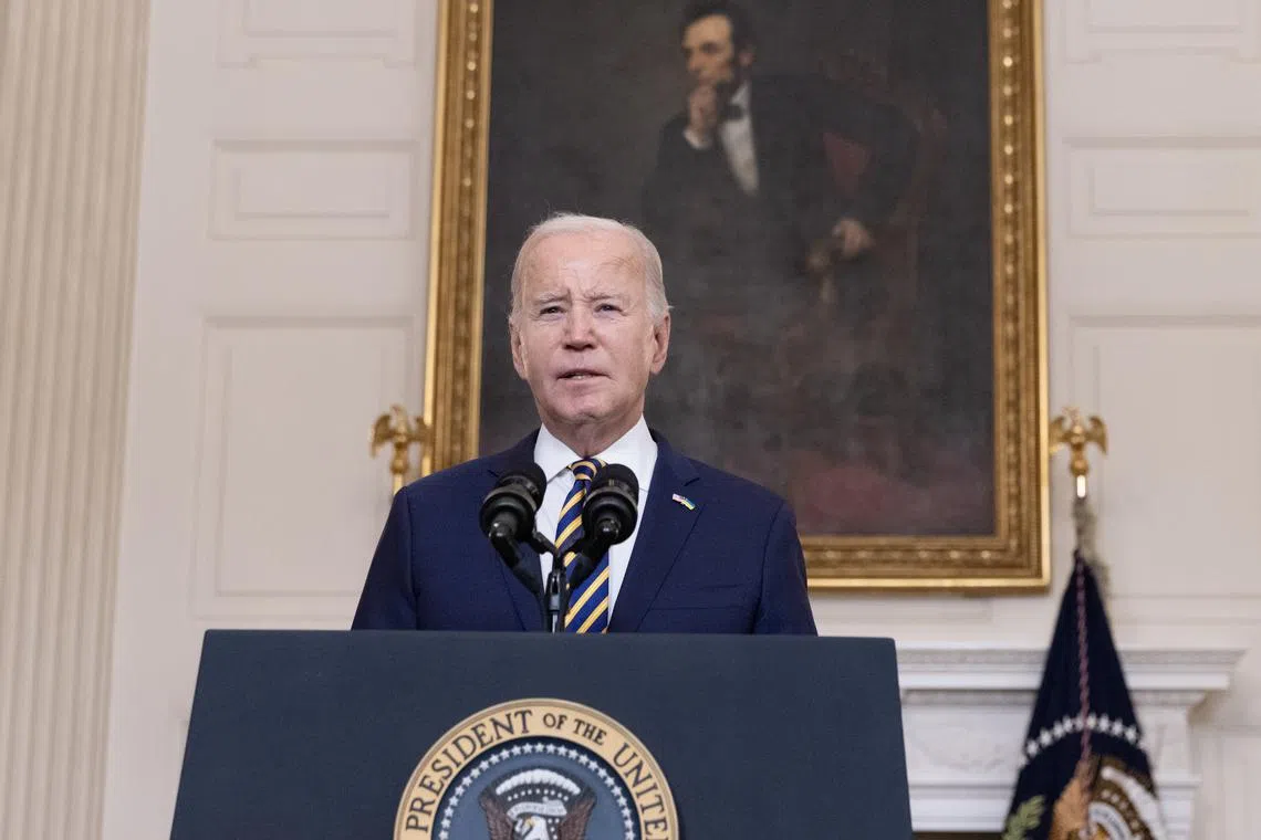 US President Joe Biden delivers remarks urging in front of a portrait of the sixteenth US President Abraham Lincoln.
