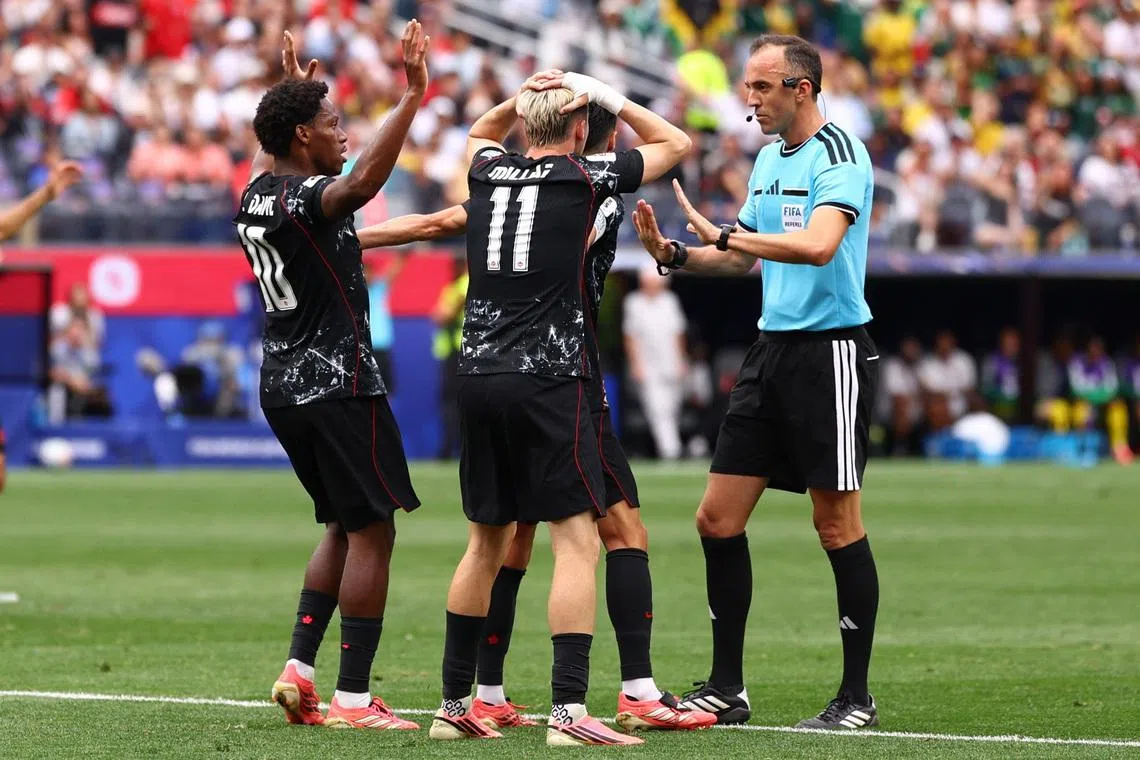 Canada’s Stephen Eustaquio, Liam Millar and Jonathan David appealing for a penalty to the referee during their 1-0 World Cup win over South Africa on June 28.