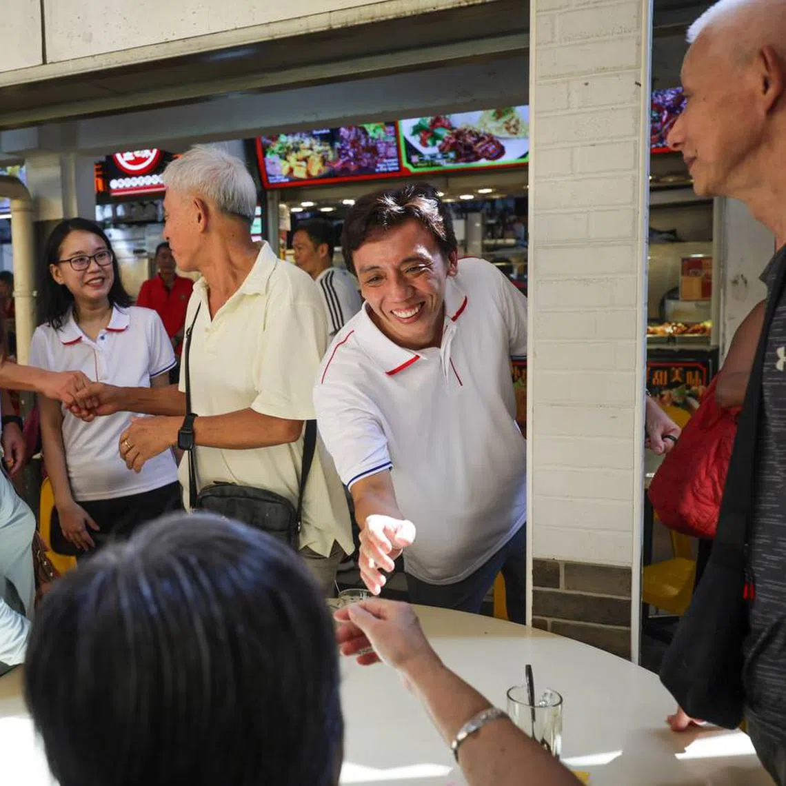 (From left) Chua Chu Kang GRC MPs Zhulkarnain Abdul Rahim, Tan See Leng, Choo Pei Ling and Jeffrey Siow (reaching out to shake a resident’s hand) meeting residents at a coffee shop in Teck Whye Lane on Aug 10. 