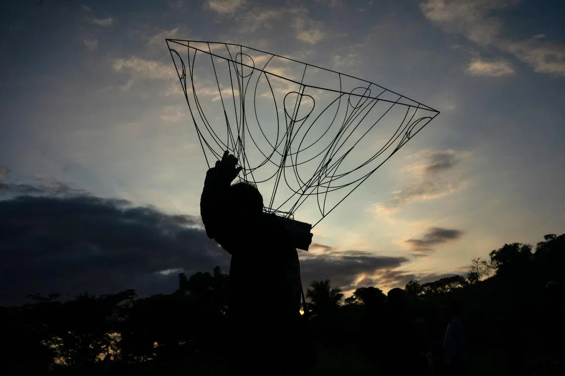 A hot air balloon enthusiast carrying a frame during preparations to fly balloons to pay tribute to mothers on Mother's Day in Rio de Janeiro, Brazil, on May 14.