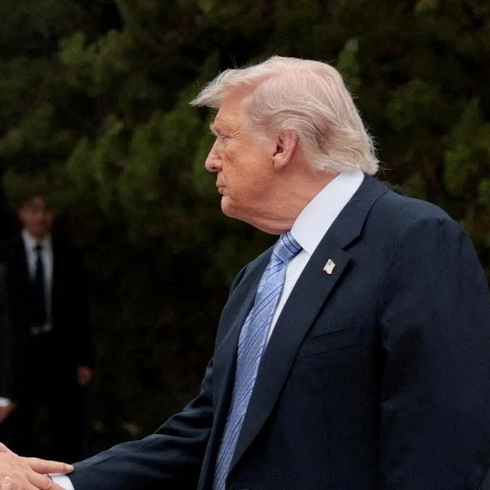 US President Donald Trump shakes hands with Chinese President Xi Jinping after a visit in Beijing, China, on May 15.