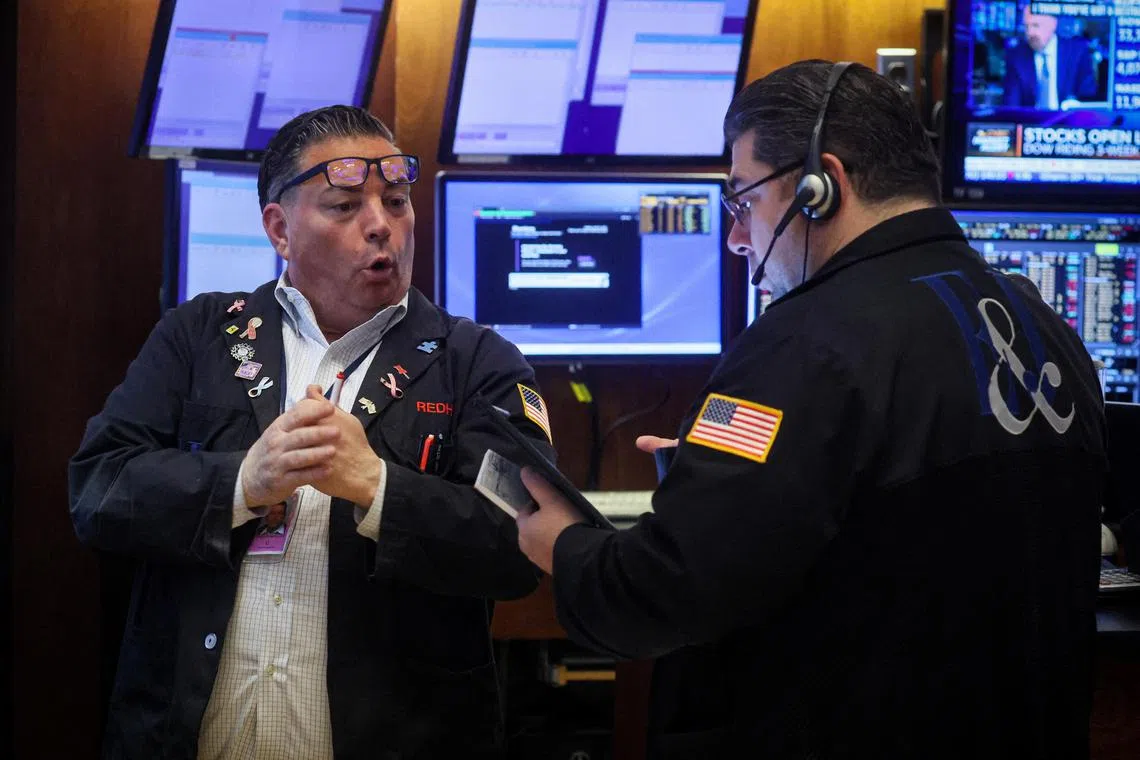 Traders work on the floor of the New York Stock Exchange, in New York City.