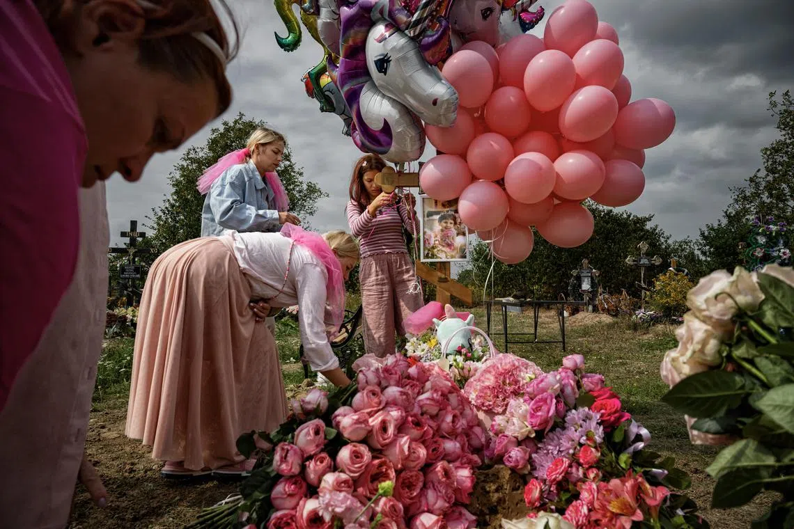 Friends and loved ones decorate the grave of Sonya Liakh, 6, after she succumbed to a four-year battle with cancer, in Chernivtsi, Ukraine on Aug. 22, 2024. RussiaÕs invasion had uprooted SonyaÕs life, as it had so many in Ukraine. It had killed her father at the front line and dealt a debilitating blow to her health, delaying her chemotherapy and allowing a rare form of cancer to ravage her body. (Lynsey Addario/The New York Times) Ñ NO SALES