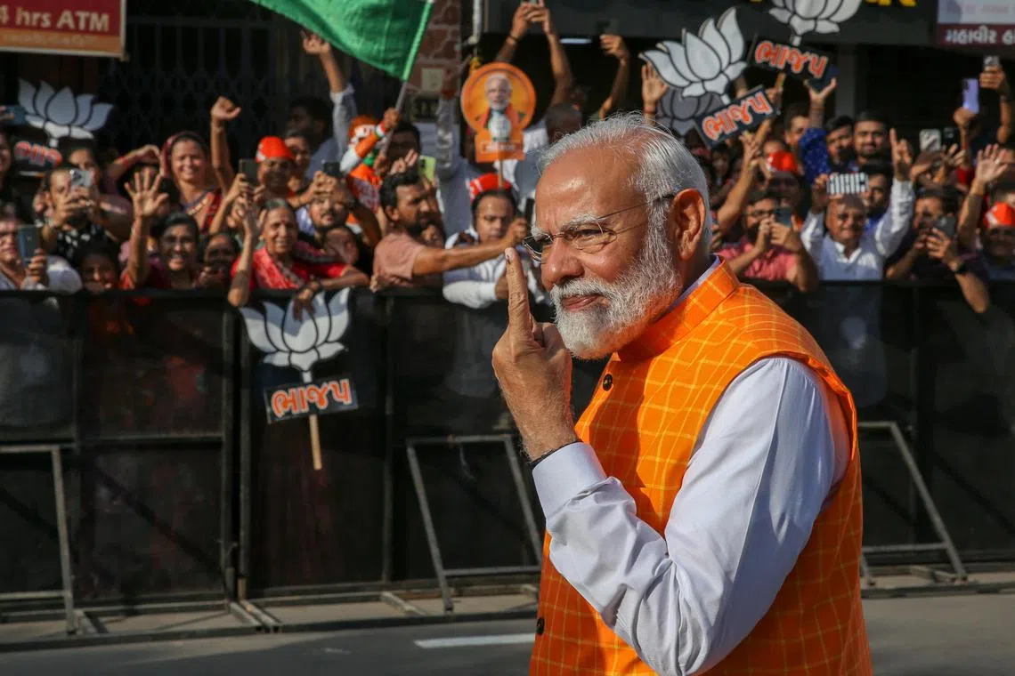 Mr Modi shows his ink-marked finger after casting his vote for the third phase of general elections in Ahmedabad, Gujarat.