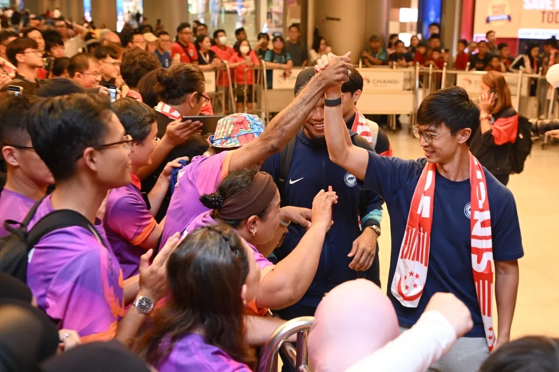 The Lions interim coach Gavin Lee greeting fans at Changi Airport on Nov 19 after returning home from their historic Asian Cup qualification in Hong Kong. 
