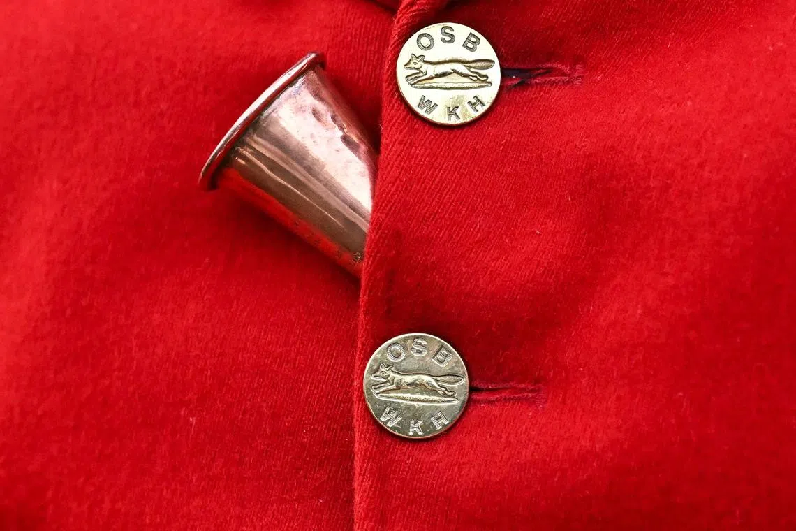 A horn placed between the buttons of the jacket of the master of the Old Surrey, Burstow and West Kent Hunt during a gathering at Chiddingstone Castle for their annual Boxing Day hunt, south of London on Dec 26, 2023.