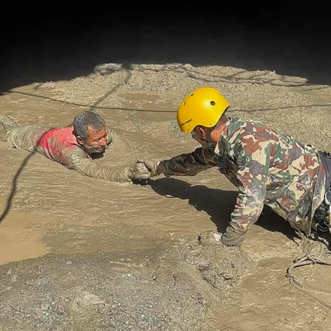 Nepal army personnel rescuing survivors from a hydropower tunnel on Aug 28, following flash floods.