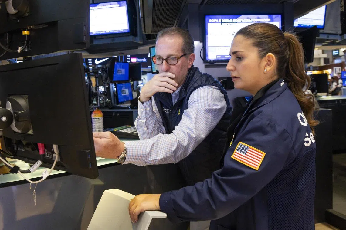 Traders work on the floor of the New York Stock Exchange, in New York City.