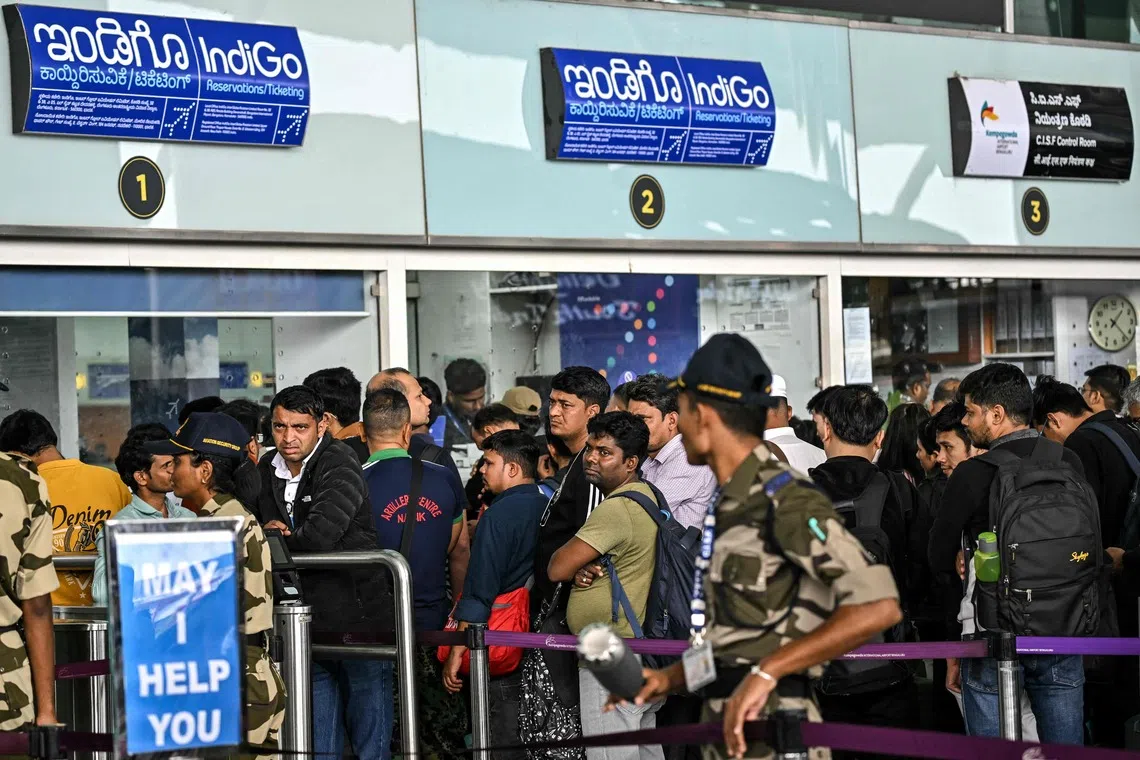Passengers waiting outside the IndiGo Airlines kiosk at the Kempegowda International Airport in Bengaluru on Dec 6.