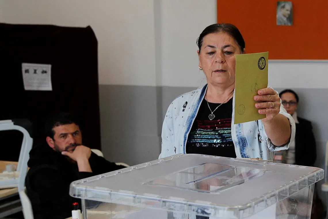A woman votes during the second round of Turkey's presidential election, in Istanbul, on May 28, 2023.