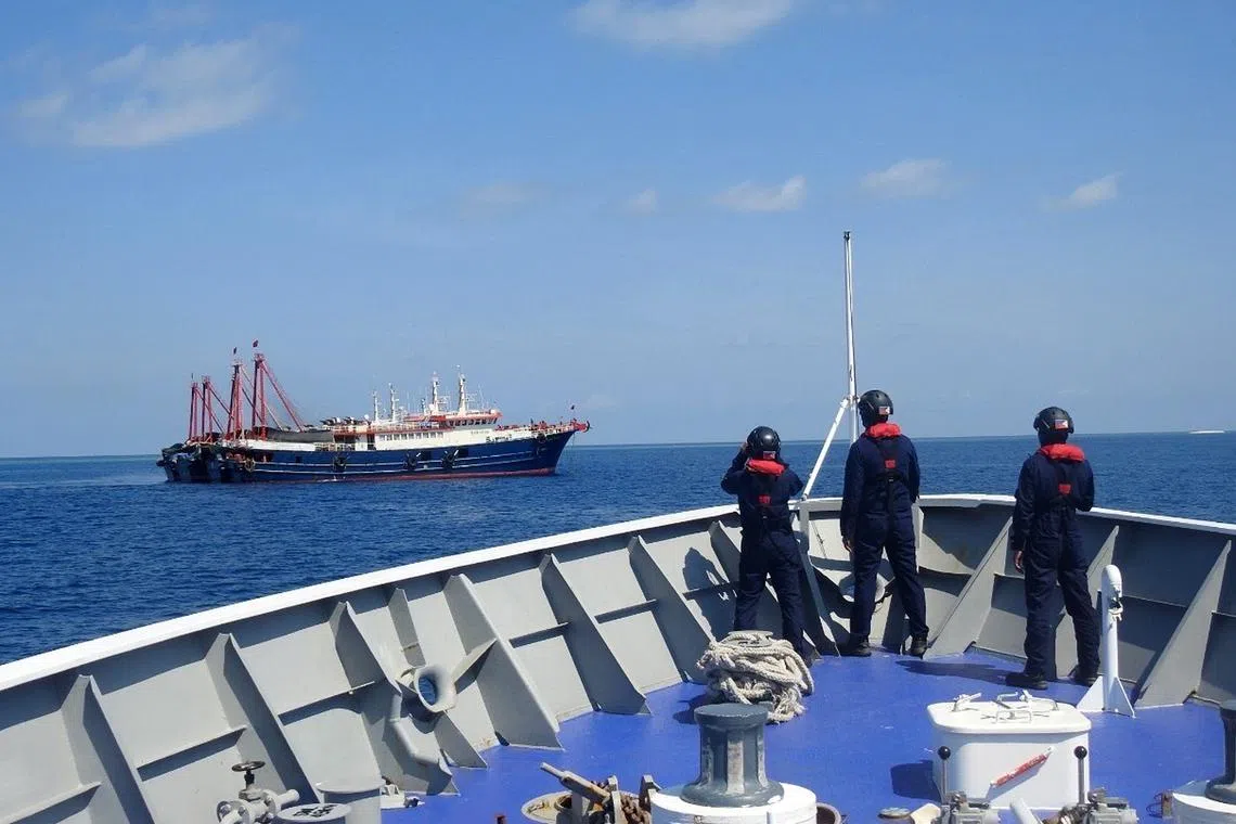 Filipino coastguard personnel monitoring Chinese vessels in the disputed South China Sea in a file photo on April 27, 2021. 