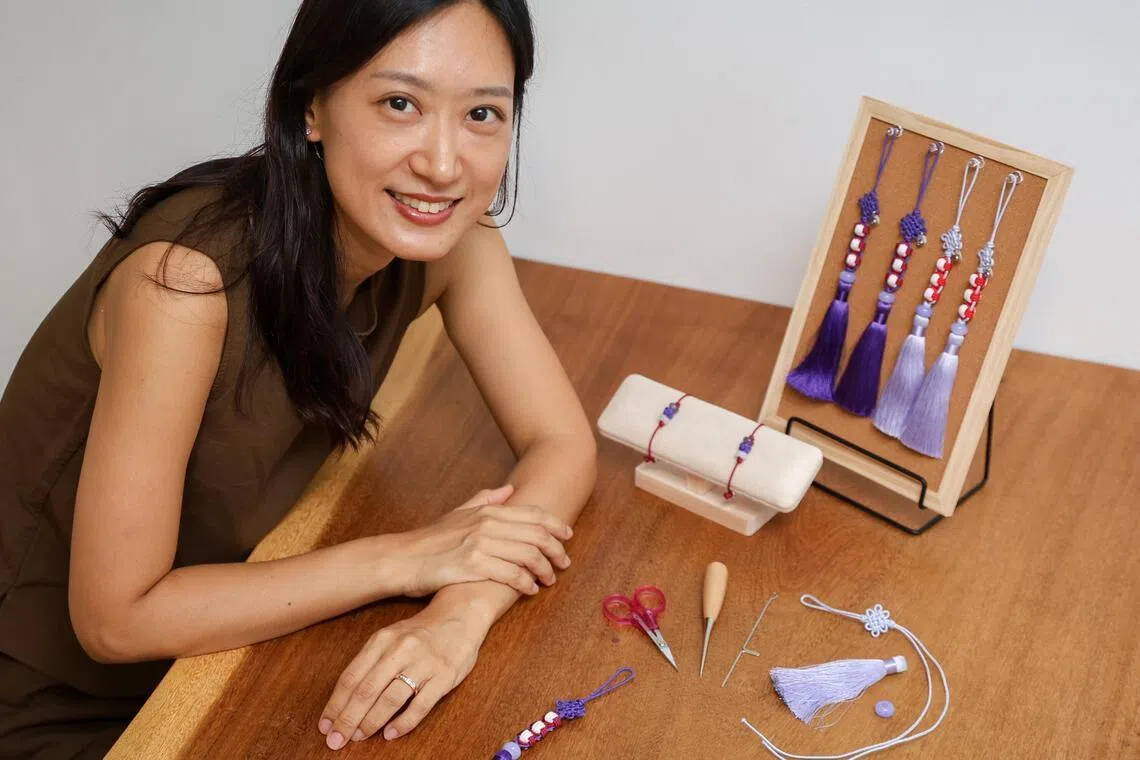 ST20260525_202697800794/Sarah Lee/jsknot04

Ms Suna Kim, 40, who sells traditional Korean knot (maedeup) accessories, pictured with her BTS-inspired norigae and bracelets in her home on May 25, 2026. ST PHOTO: SARAH LEE