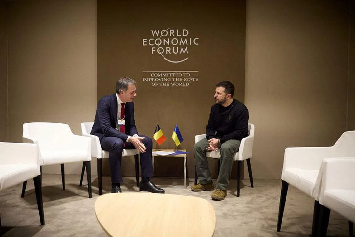 FILE PHOTO: Ukraine's President Volodymyr Zelenskiy and Belgium's Prime Minister Alexander De Croo attend a meeting during the World Economic Forum (WEF) in Davos, Switzerland January 16, 2024. Ukrainian Presidential Press Service/Handout via REUTERS/File Photo