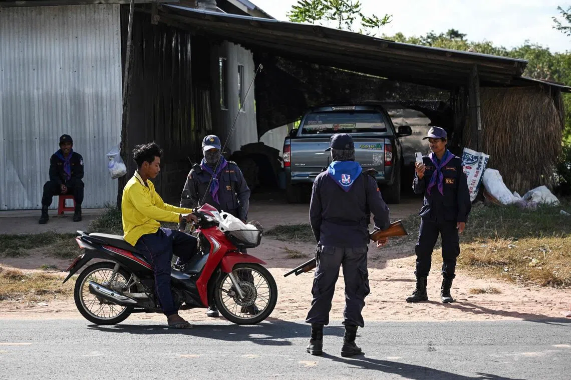 Thai volunteers conduct security checks in the Thai province of Buriram, 10km from the border with Cambodia, on Dec 13, 2025. 