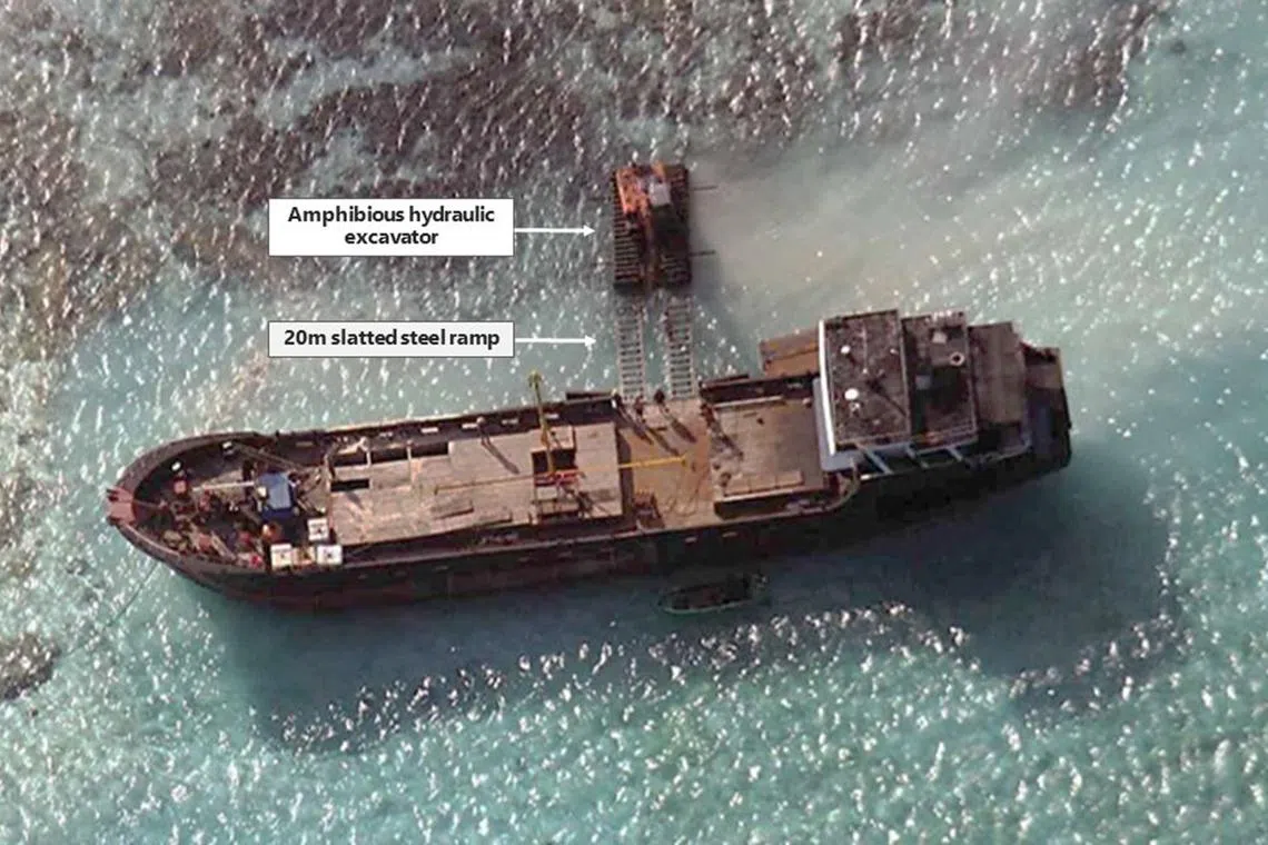A Chinese maritime militia vessel is pictured offloading an excavator at Eldad Reef in 2014 in this satellite image obtained by Bloomberg News.