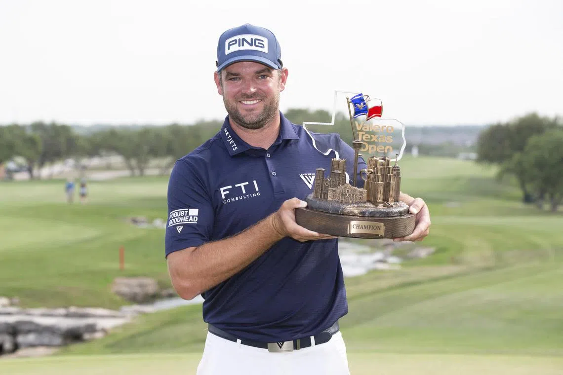 Corey Conners posing with the winner's trophy after winning the Texas Open at TPC San Antonio. 