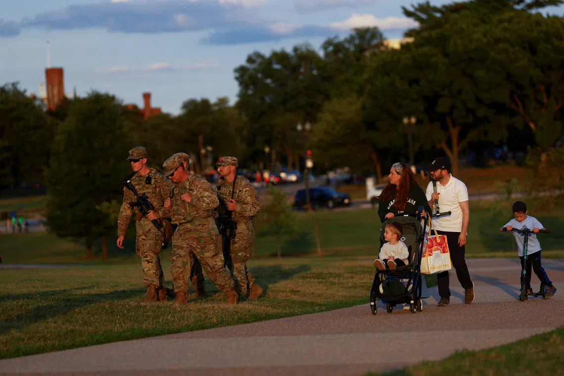 FILE PHOTO: Members of the National Guard carry firearms while patrolling the National Mall, weeks after U.S. President Donald Trump ordered the National Guard and law enforcement to patrol the nation's capital to assist in crime prevention, in Washington, D.C., U.S., August 26, 2025. REUTERS/Jose Luis Gonzalez/File Photo