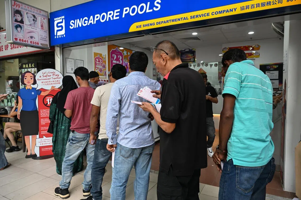 Foreign workers at a Singapore Pools outlet at City Plaza on July 12, 2026.