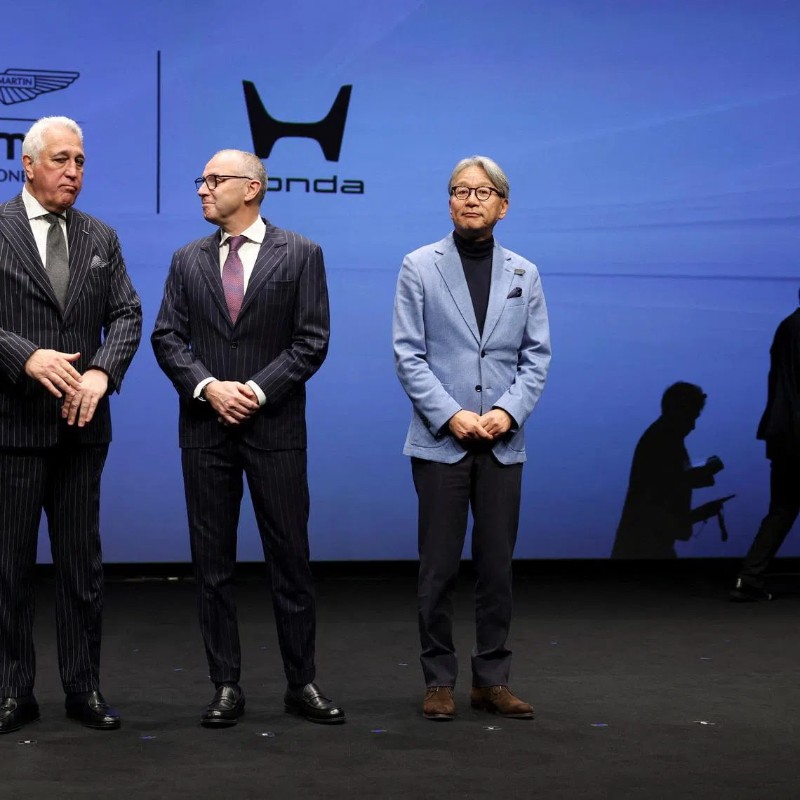 Aston Martin Aramco Formula One Team Executive Chairman Lawrence Stroll, Formula One Group President and F1 CEO Stefano Domenicali and Honda CEO Toshihiro Mibe prepare for a photo session during their joint press conference on their partnership launch announcement in Tokyo, Japan, January 20, 2026.   REUTERS/Issei Kato