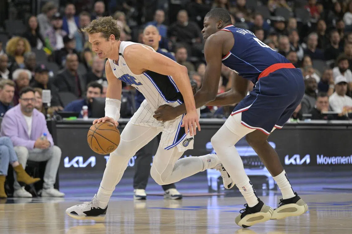 FILE PHOTO: Nov 20, 2024; Inglewood, California, USA;  Orlando Magic center Moritz Wagner (21) drives past Los Angeles Clippers center Mo Bamba (4) in the second half at Intuit Dome. Mandatory Credit: Jayne Kamin-Oncea-Imagn Images/File Photo