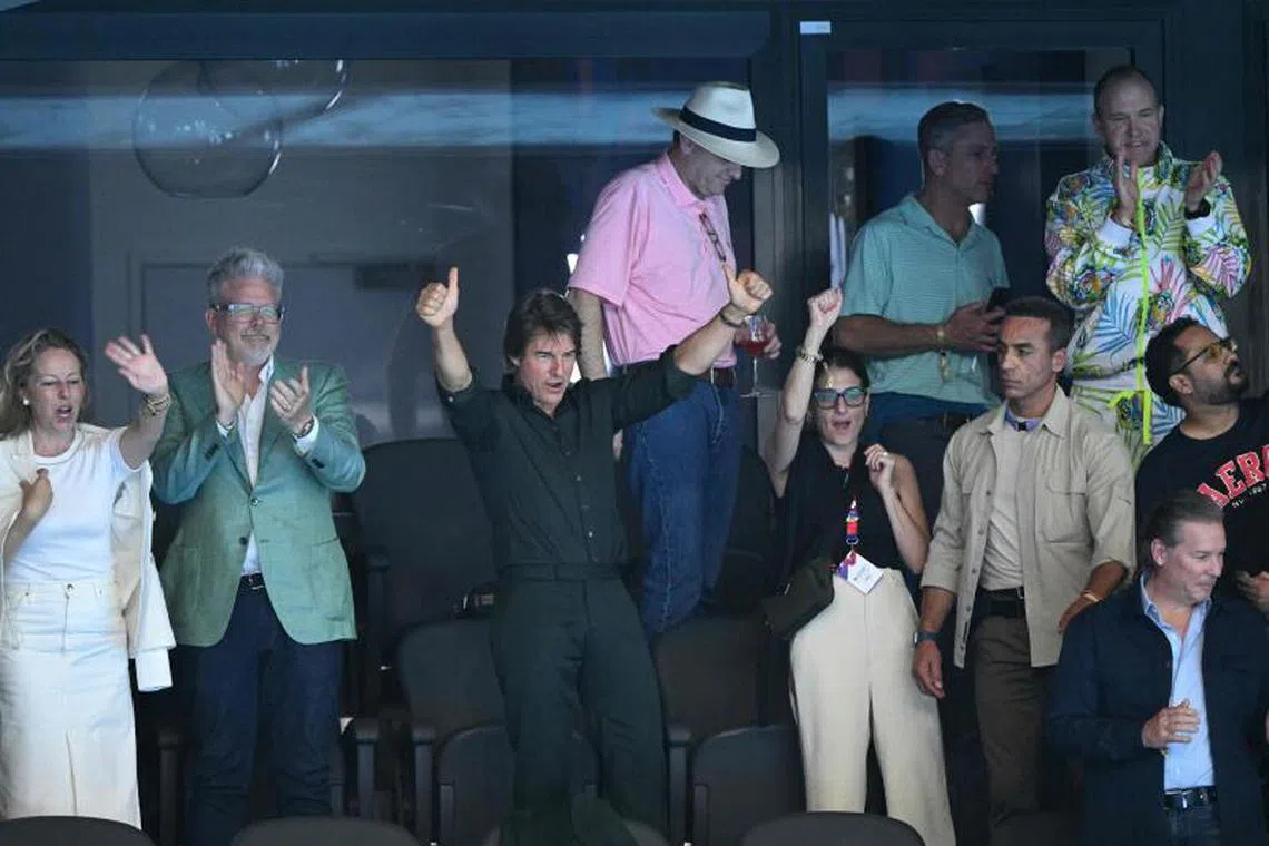 Hollywood star Tom Cruise watches the victory ceremony of the women's 4x100m freestyle relay swimming event at the Paris 2024 Olympic Games at the Paris La Defense Arena in Nanterre, west of Paris, on July 27, 2024. 