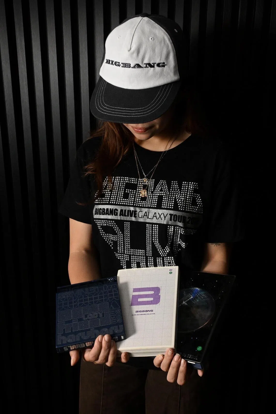 Priscilla Koh has been a fan of the band since her junior college days. She wears her 2012 Alive concert T-shirt and holds her old BigBang albums.