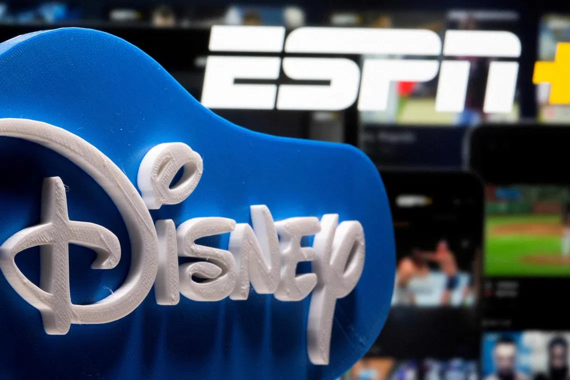 A 3D printed Disney logo is seen in front of the ESPN+ logo in this illustration.