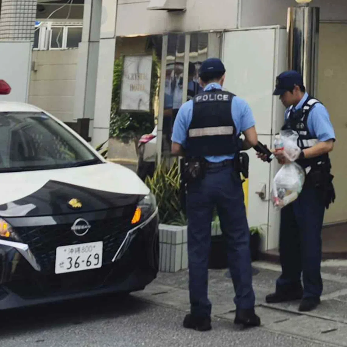 Police officers near a hotel where a woman was found dead in Naha, in Japan’s Okinawa prefecture, on Oct 4.