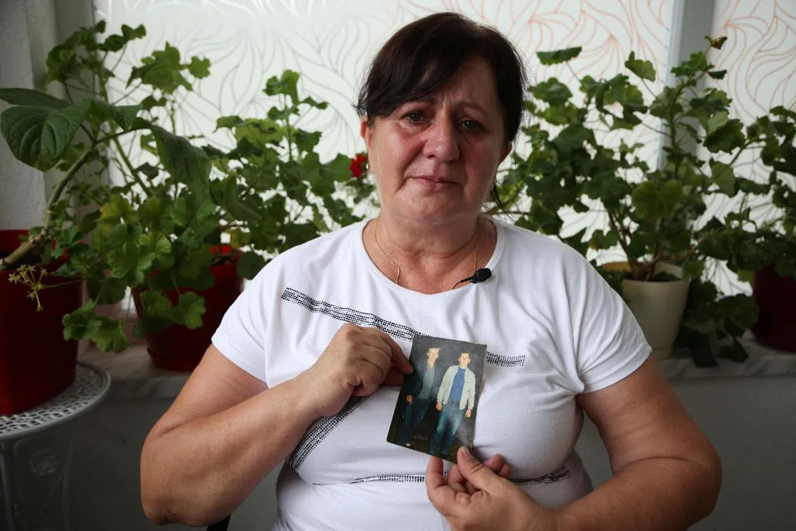 Mevlida Omerovic shows a photo of her husband Hasib (right), whose two bones she will bury on July 11, the 30th anniversary of the genocide in Srebrenica, and her relative Mensur, also killed in the genocide.