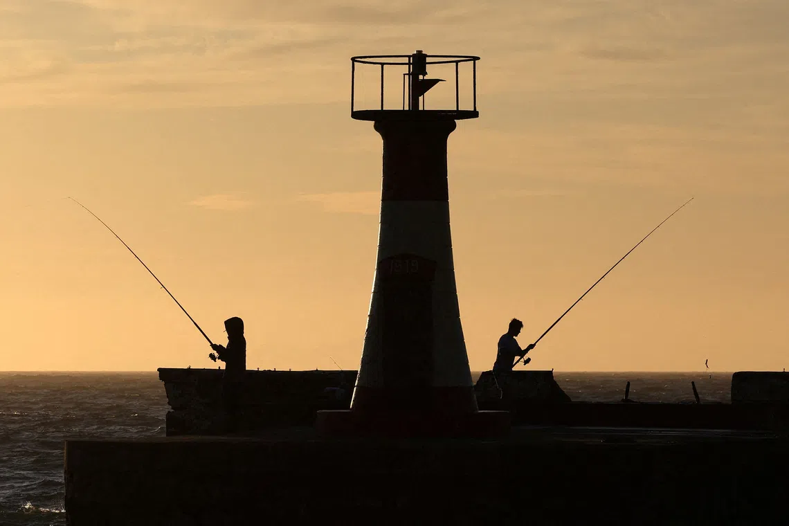 Fishermen at work on the False Bay coastline, in Cape Town, South Africa, on Dec 1, 2025. 