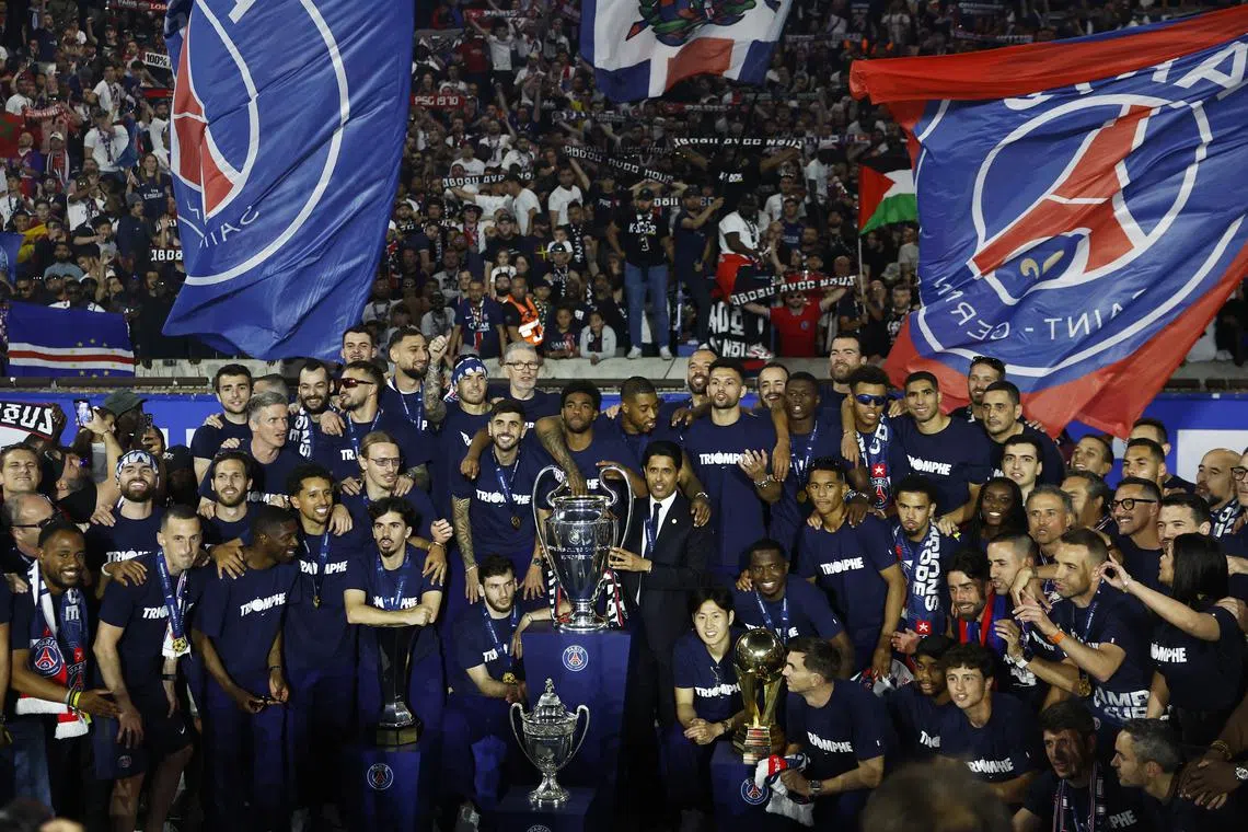 FILE PHOTO: Soccer Football - Champions League - Paris St Germain Victory Parade - Parc des Princes, Paris, France - June 1, 2025 Paris St Germain players pose for a picture with the trophy and Paris St Germain president Nasser Al-Khelaifi during the victory celebration REUTERS/Abdul Saboor/File Photo